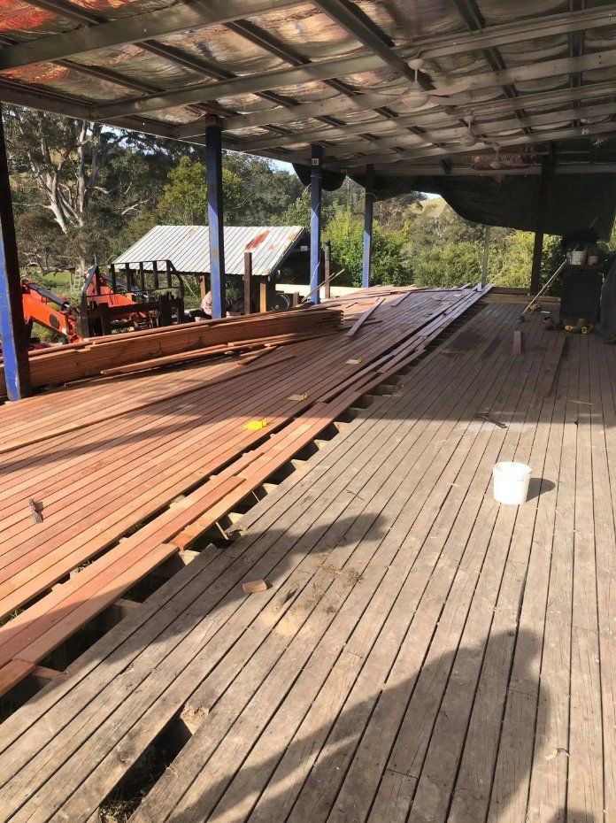 A Large Wooden Deck Is Being Built Under a Roof — Alcando Renovations & Maintenance In Harrington, NSW