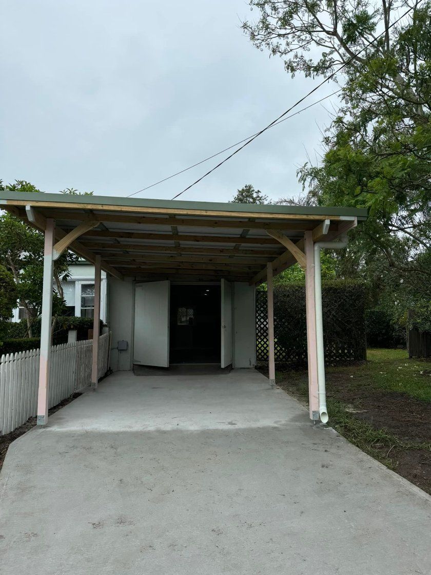 A Carport in Front of A House with A White Picket Fence — Alcando Renovations & Maintenance In Taree, NSW