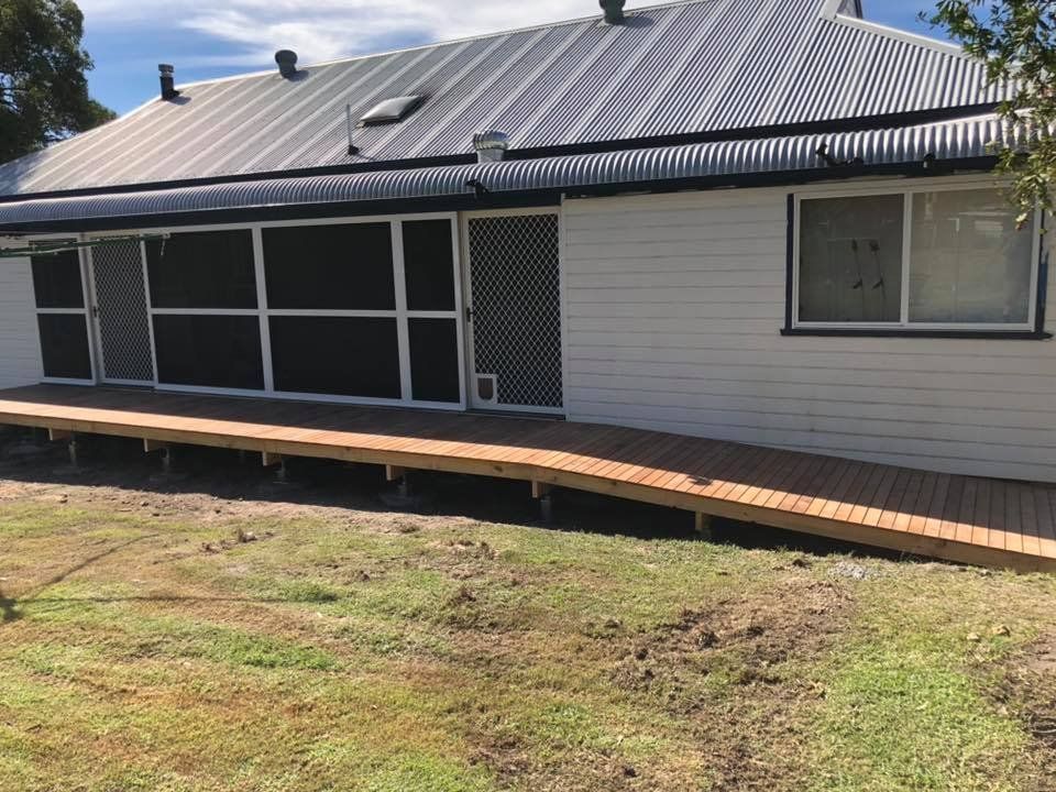 A White House with A Wooden Ramp in Front of It — Alcando Renovations & Maintenance In Forster, NSW