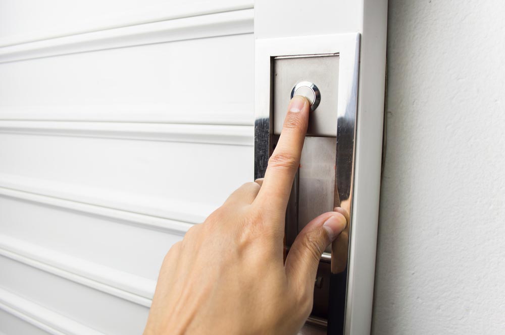 Hand Pushing The Garage Door Button — Garage Door Services In Yeppoon, QLD