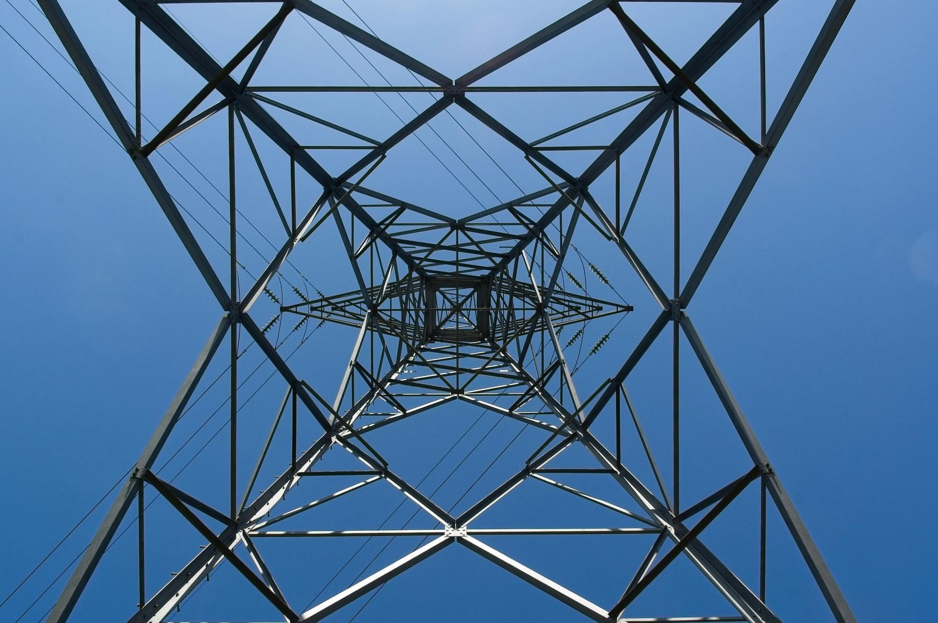 A large metal tower against a blue sky.