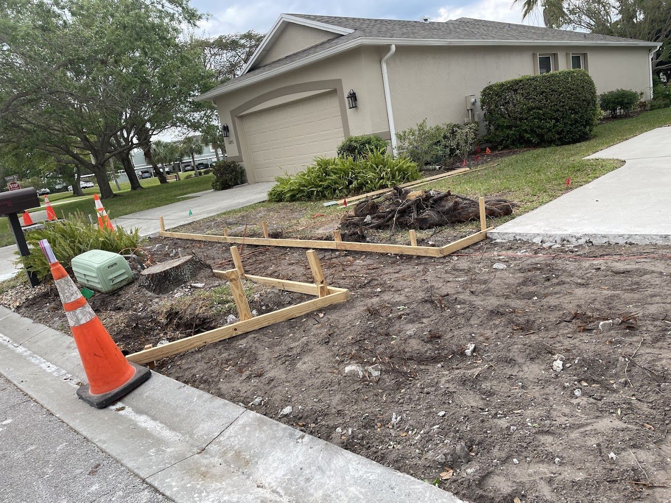 A house is being built on the side of the road next to a construction site.