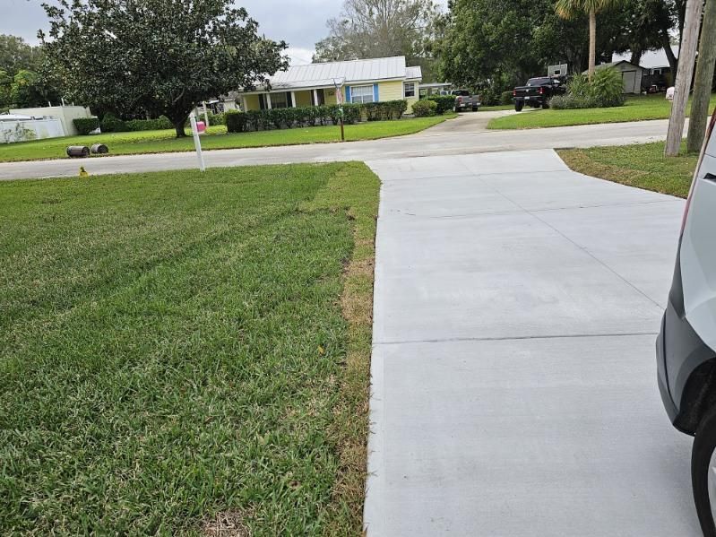A car is parked on the side of the road next to a sidewalk.