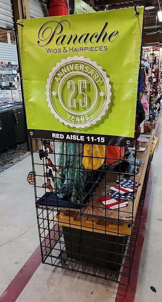 A green banner is hanging on a wire rack in a store.