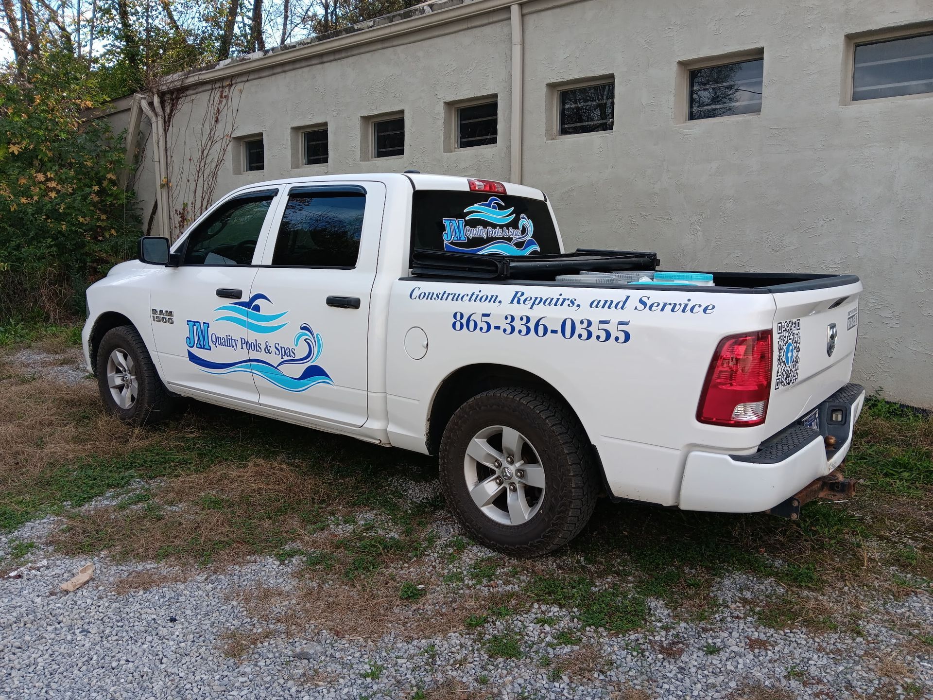 A white truck is parked in front of a building.