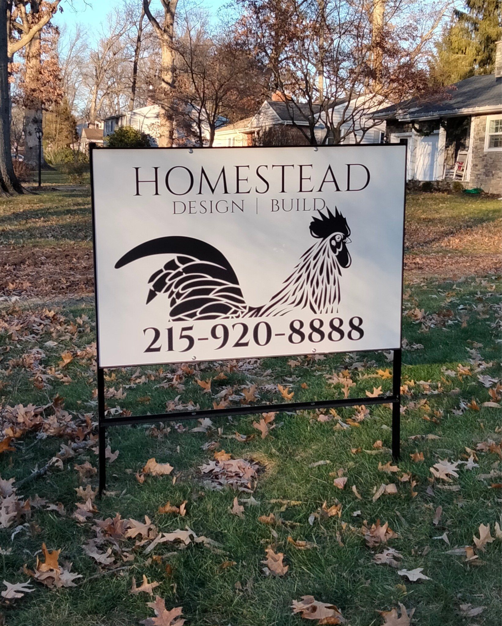 A sign with a rooster and the number 215-920-8888 on it