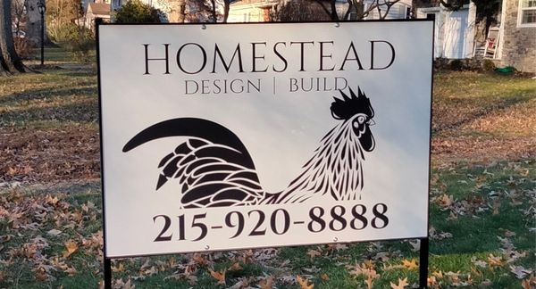 A sign for homestead design and build with a rooster on it