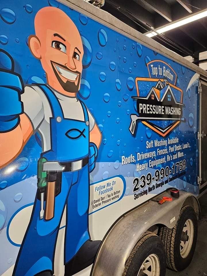 A trailer with a cartoon man on it that says pressure washing.
