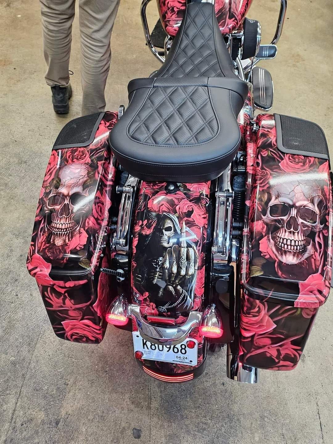 A motorcycle with skulls and roses painted on it