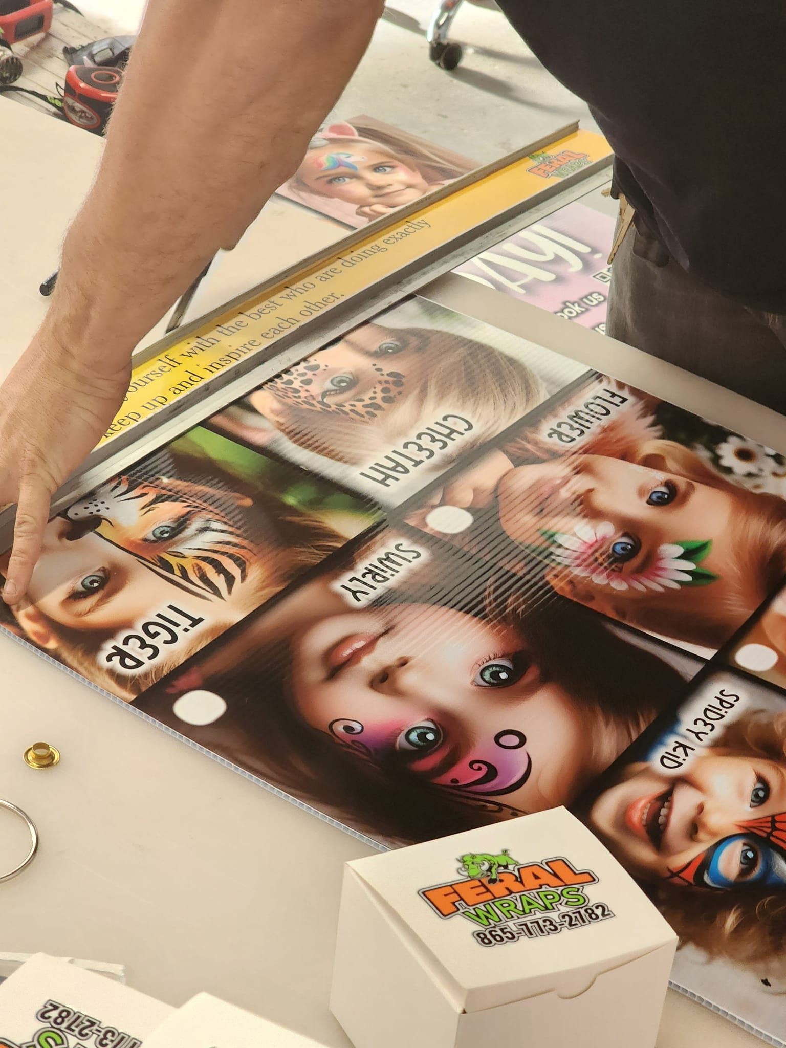 A person is putting a picture of a child 's face on a piece of paper