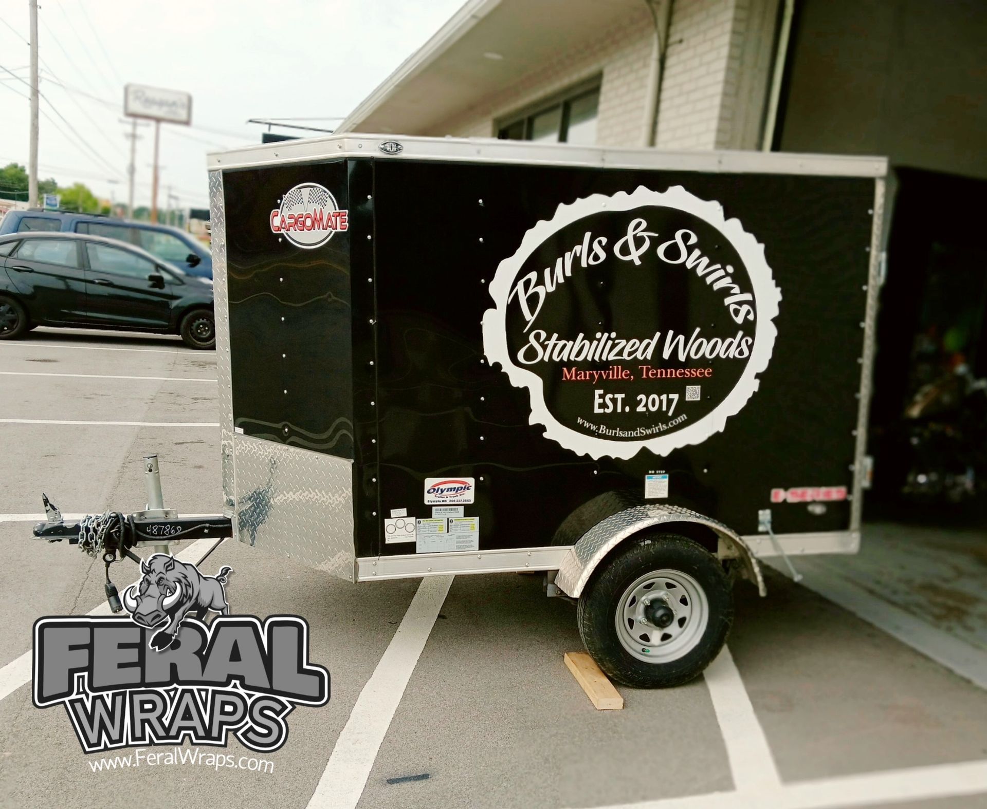 A black trailer with birds and swords written on it