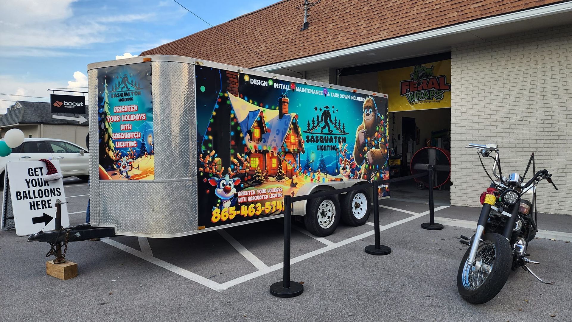 A trailer with a motorcycle parked in front of a building.