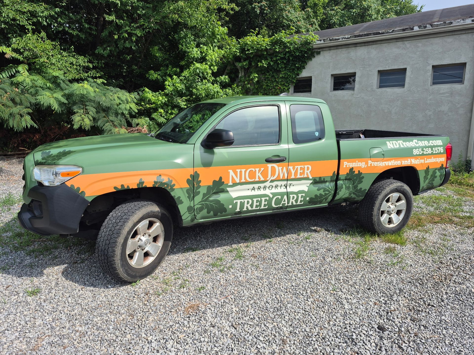 A green truck with the word nick driven on it