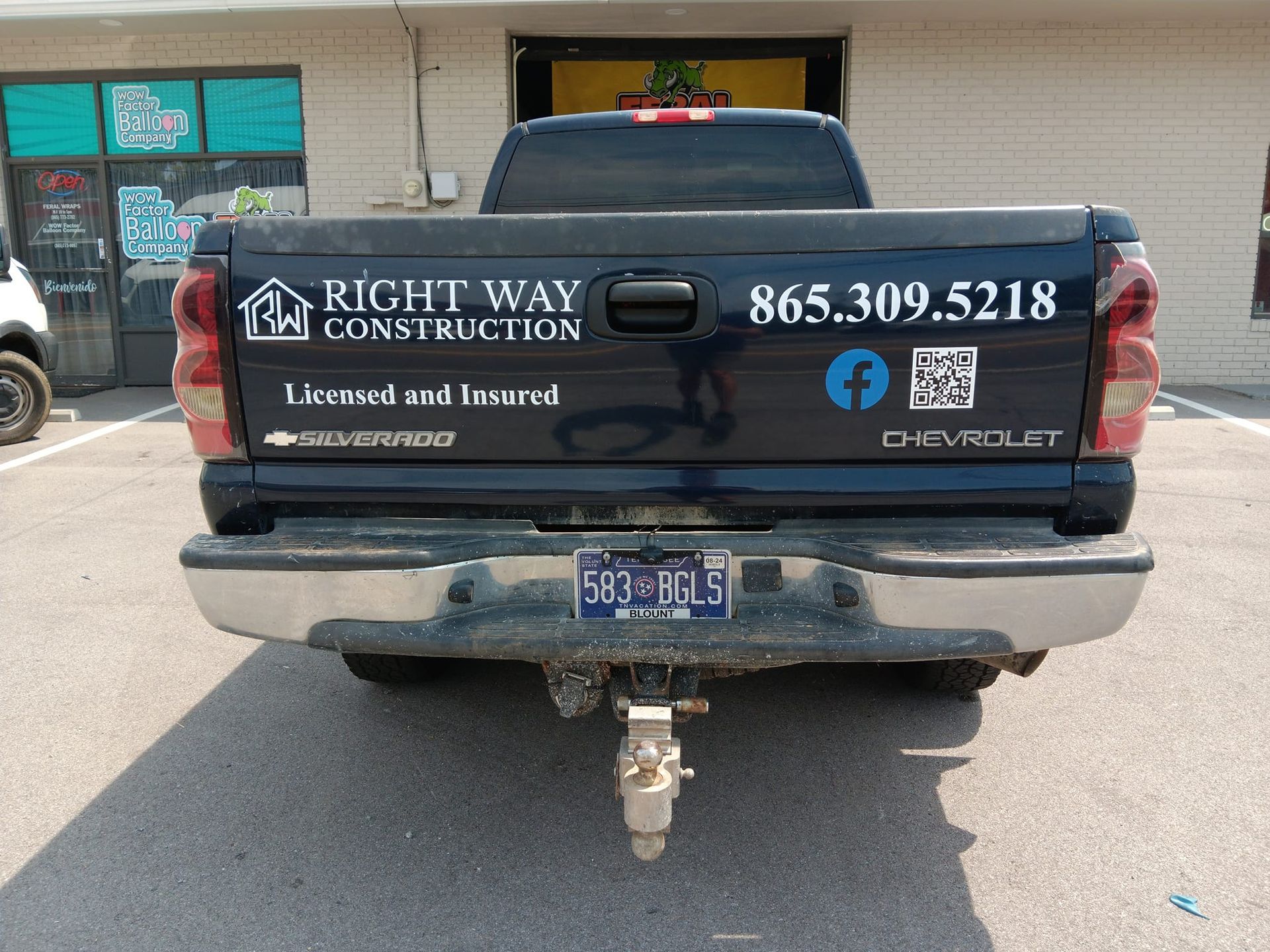 The back of a truck that says right way construction on it