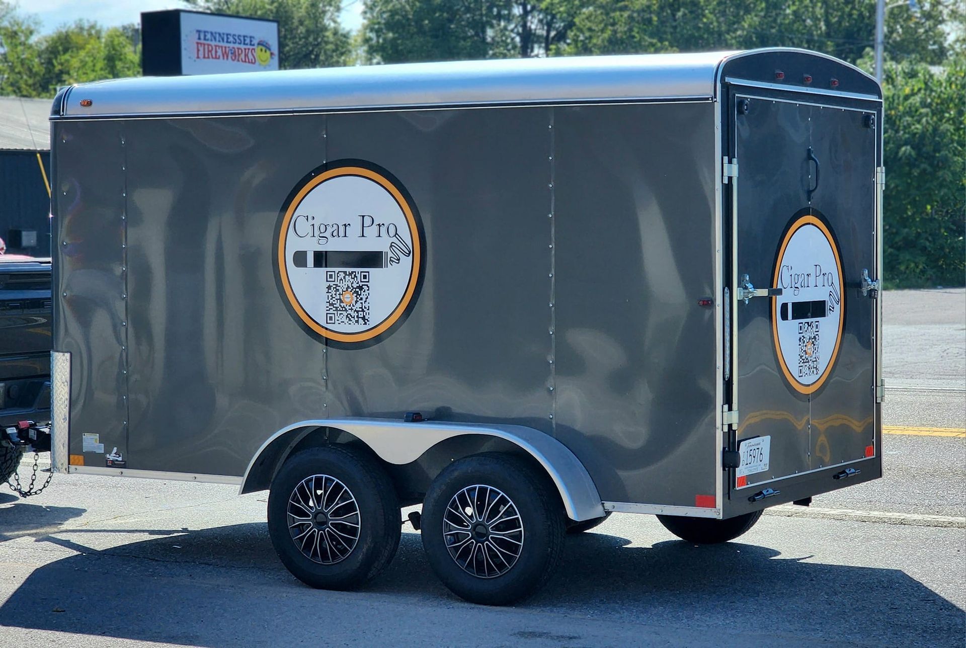 A trailer with a logo on it is parked in a parking lot