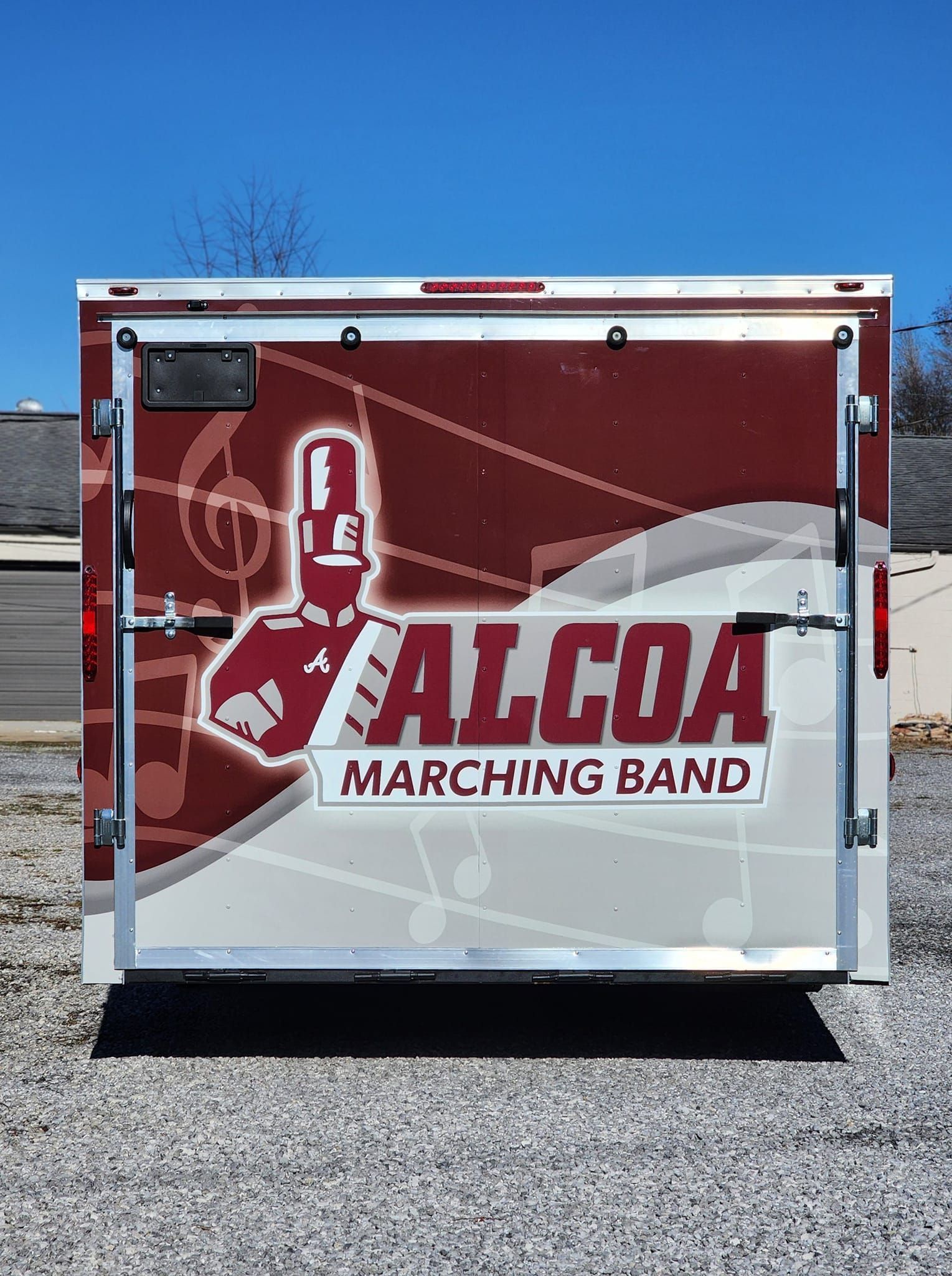 A red and white trailer for the alcoa marching band