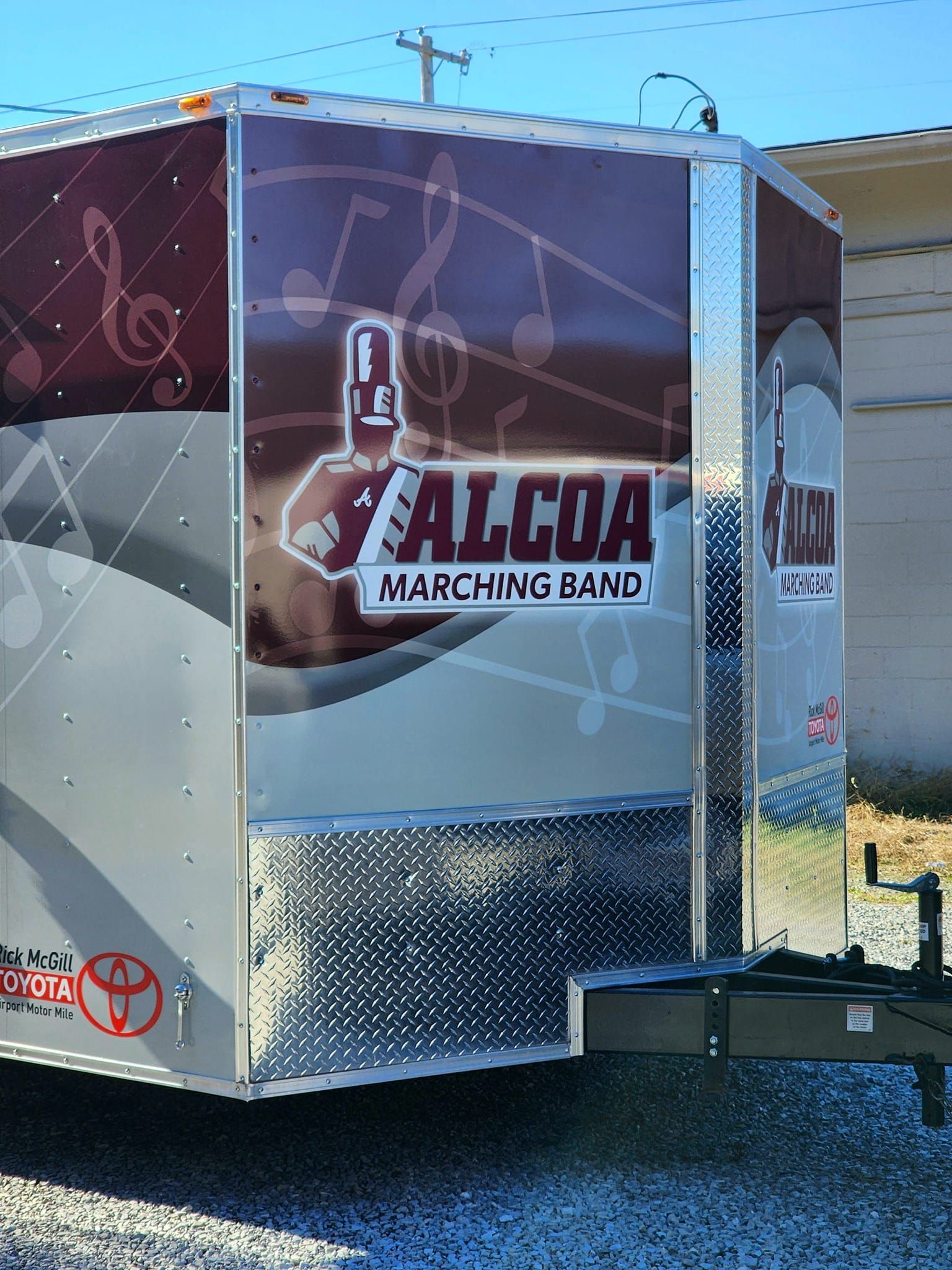 A trailer with a marching band logo on it