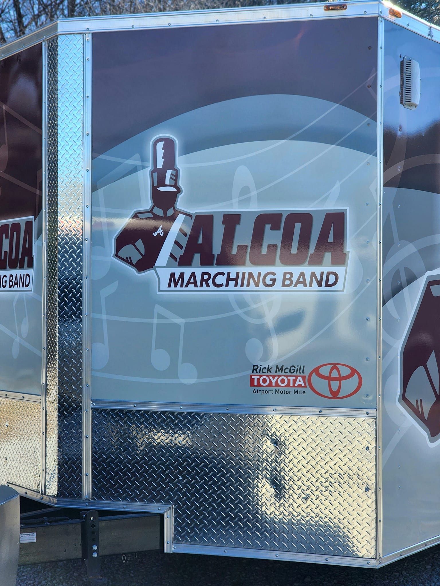 A trailer with a marching band logo on it