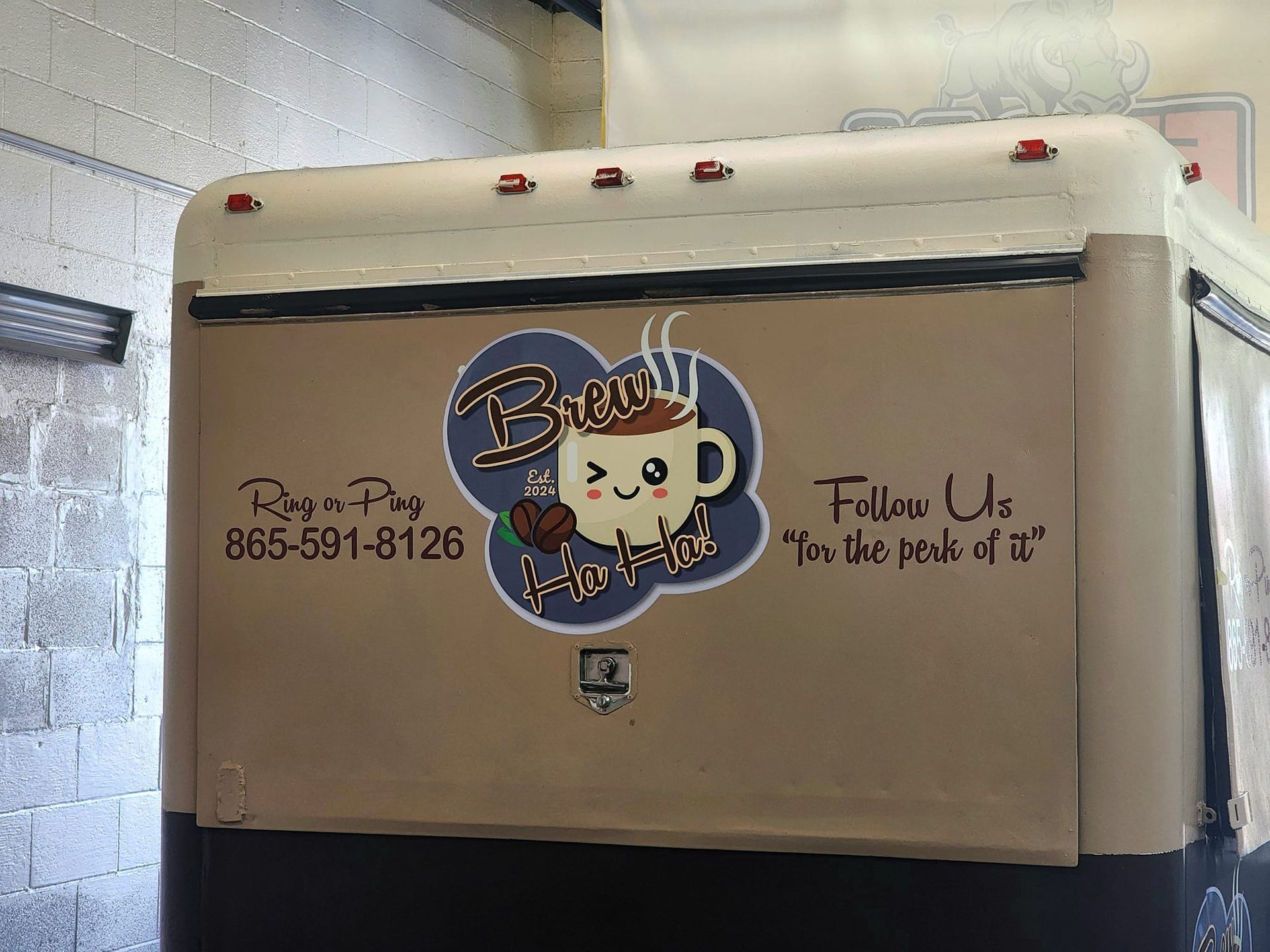 The back of a coffee truck says follow us for the peak of it