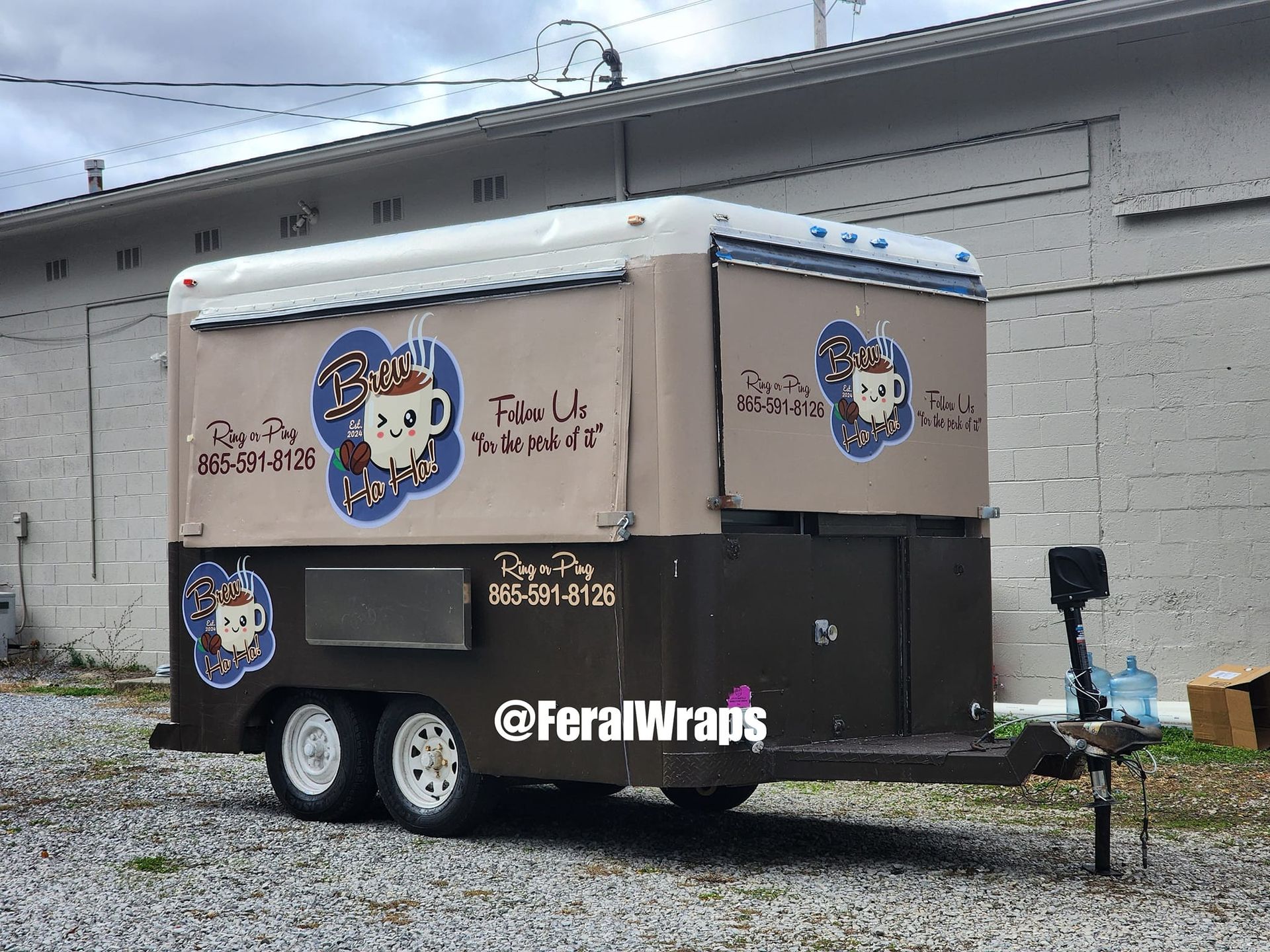 A food truck is parked in front of a building.