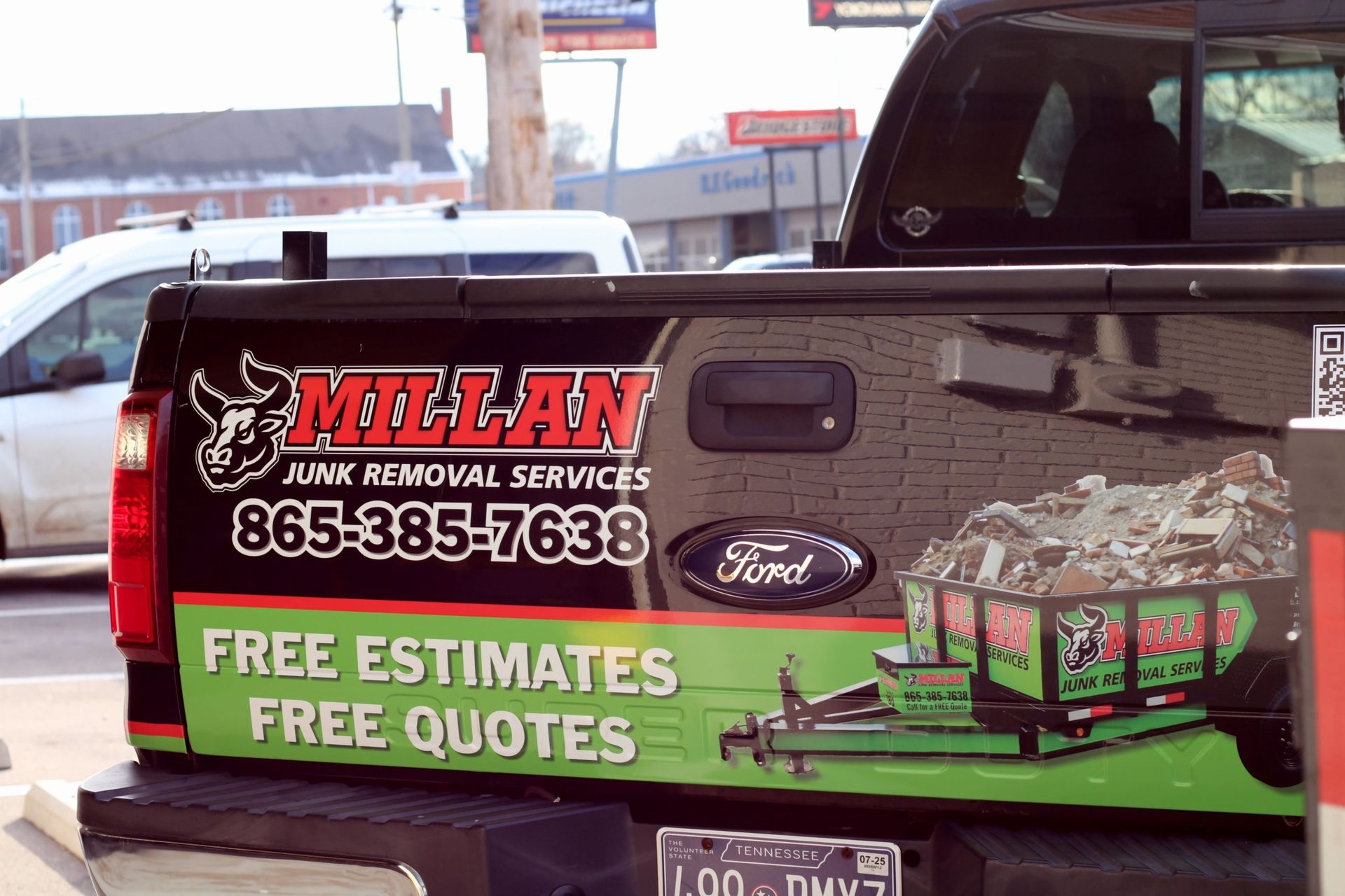 The back of a truck is advertising junk removal services.