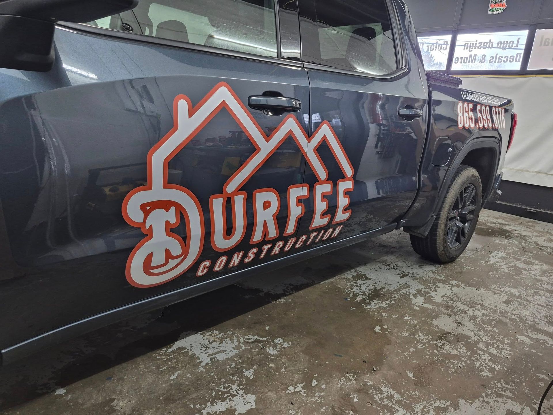 A black truck with the word urfee on the side of it.