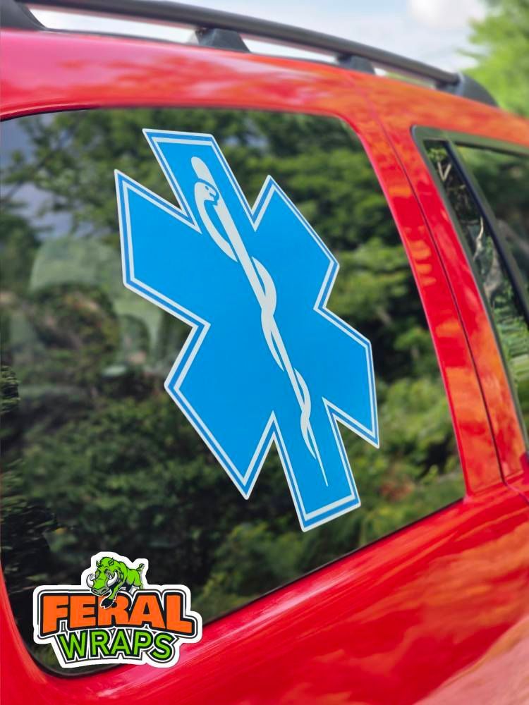A red car with a blue star of life sticker on the window