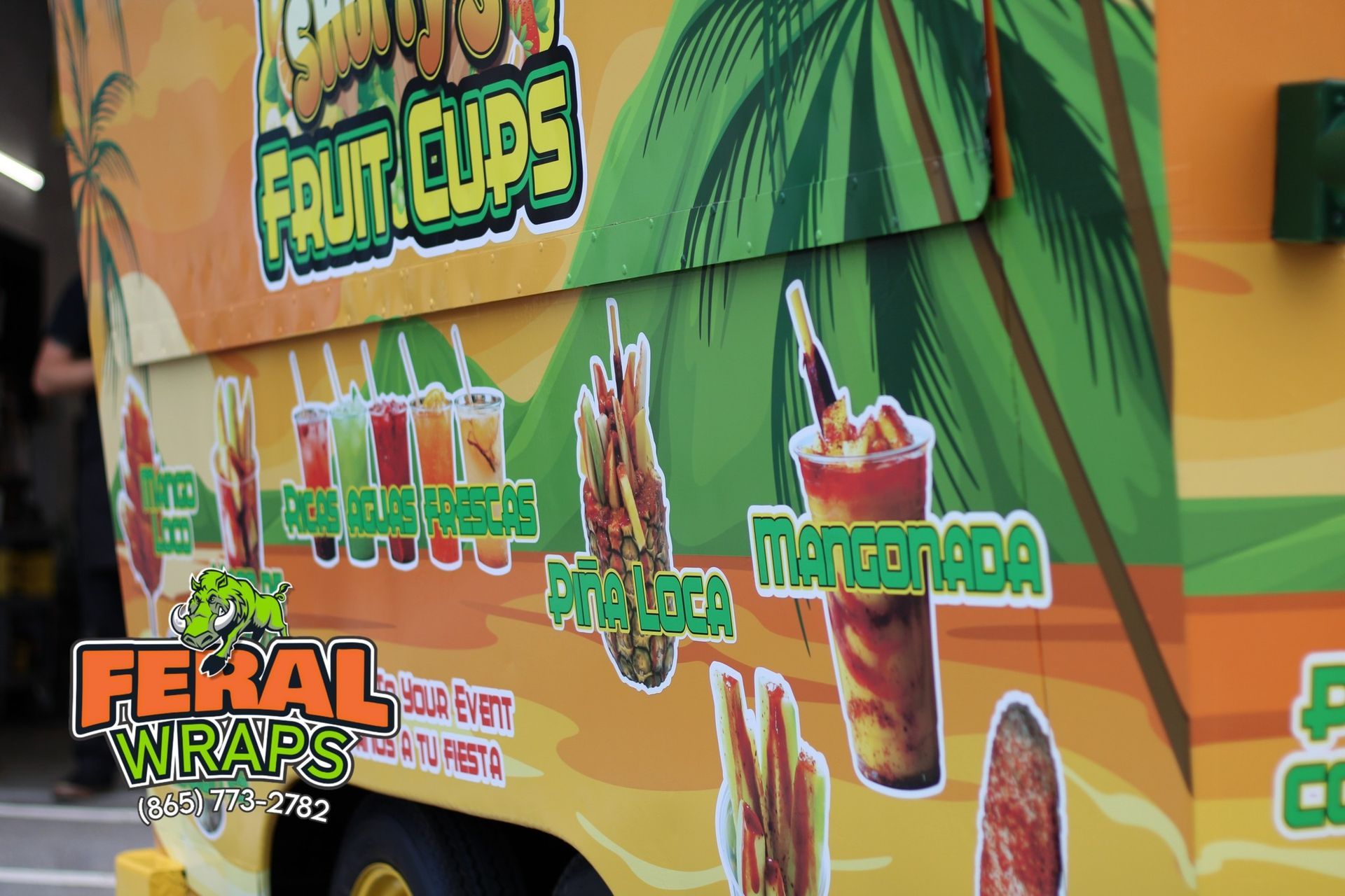 A food truck that says feral wraps on it