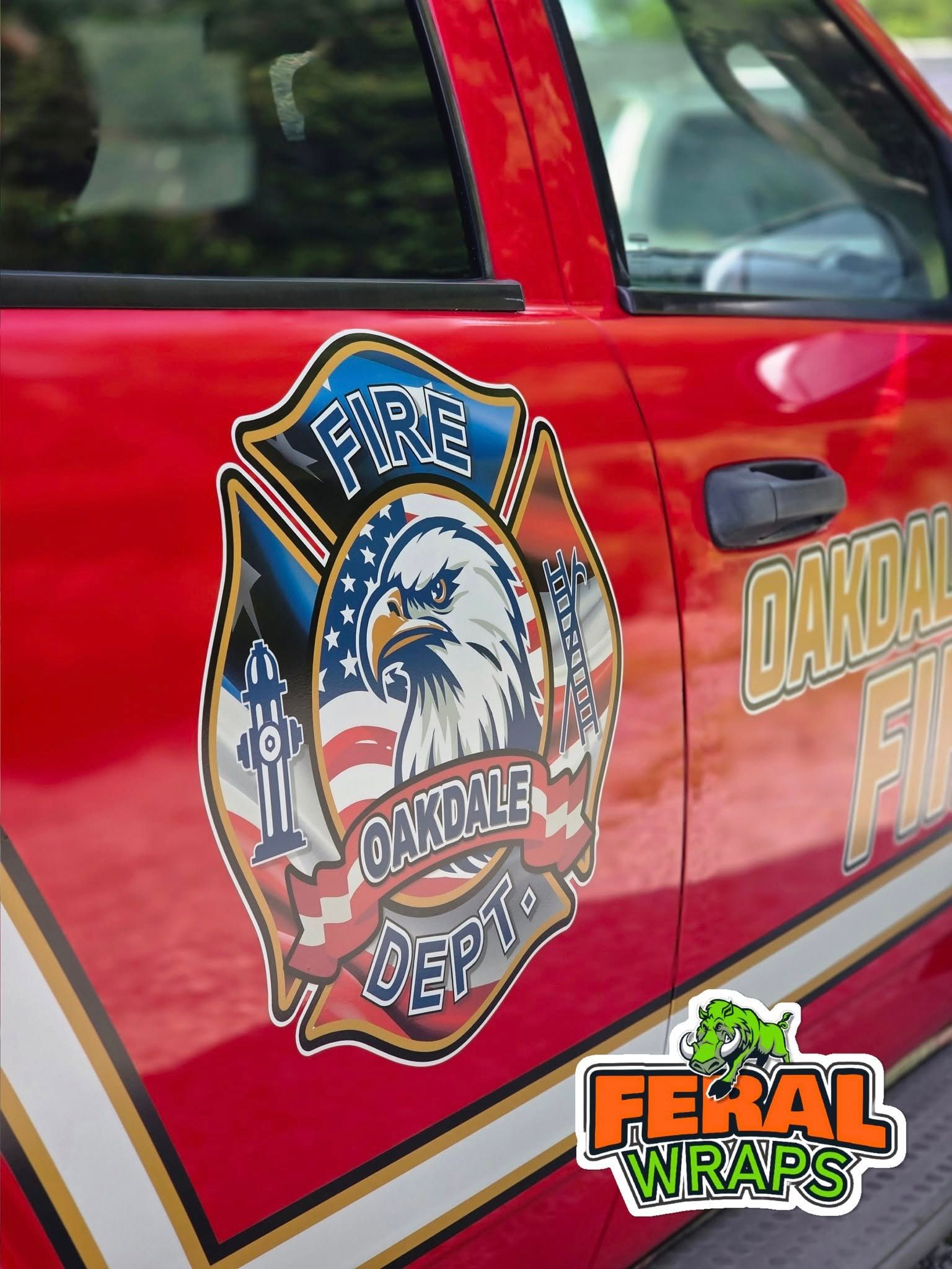 A red car with a fire department logo on it