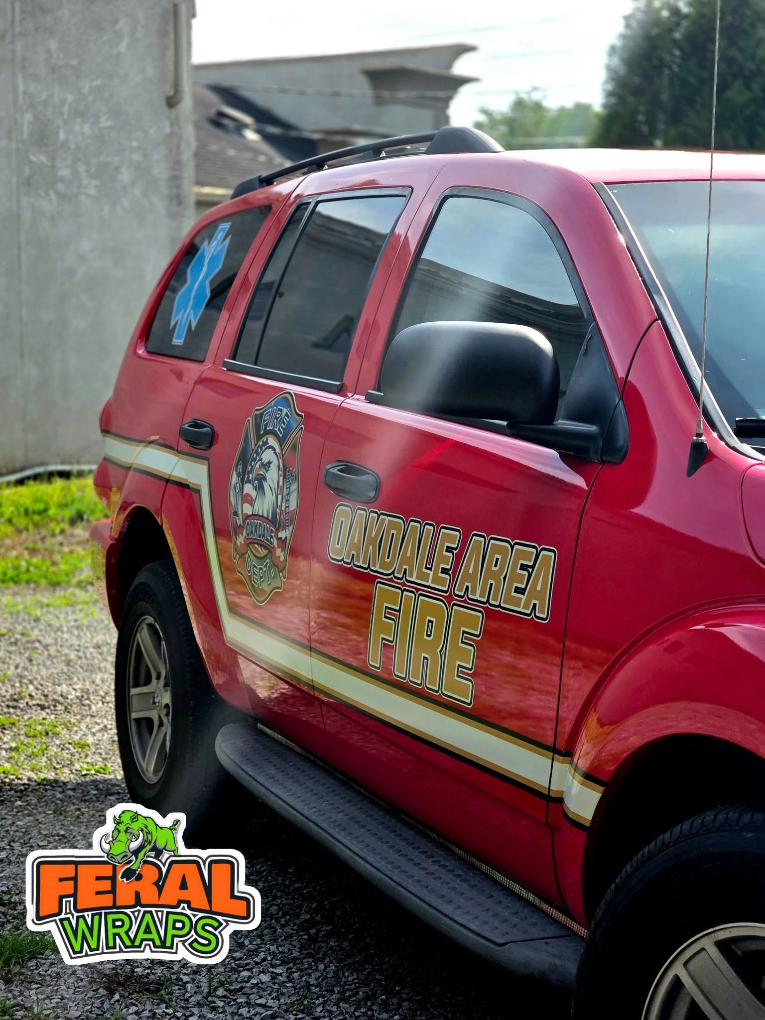 A red car with a sticker on the side that says fental wraps