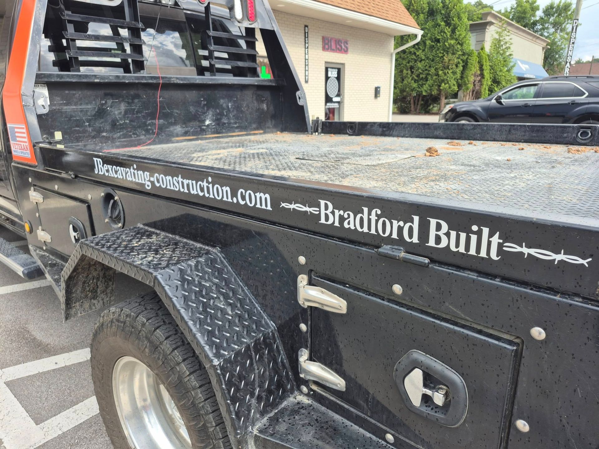 Black Bradford Built tow truck with website address on the side.