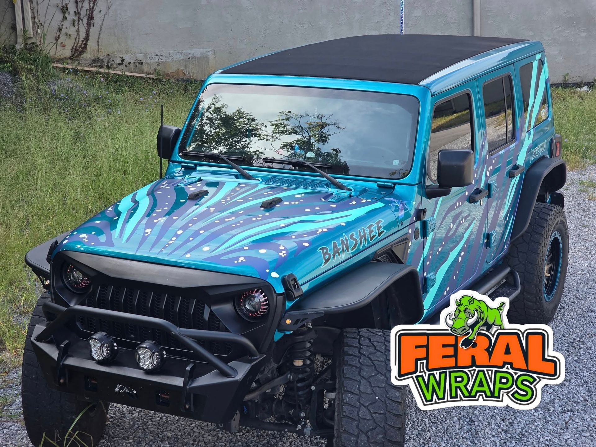 Blue Jeep Wrangler with a custom wrap and 