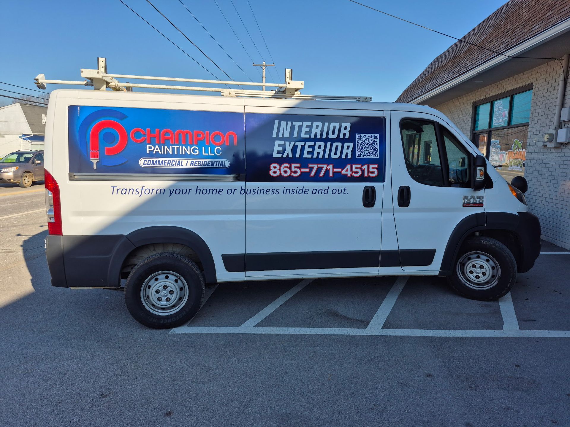 A white van that says interior exterior is parked in a parking lot