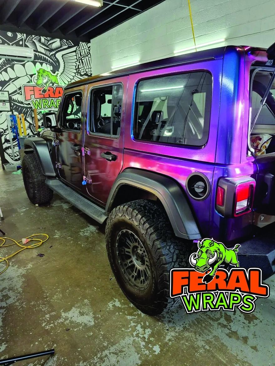 Custom-wrapped Jeep Wrangler with a color-shifting exterior in a garage setting. 