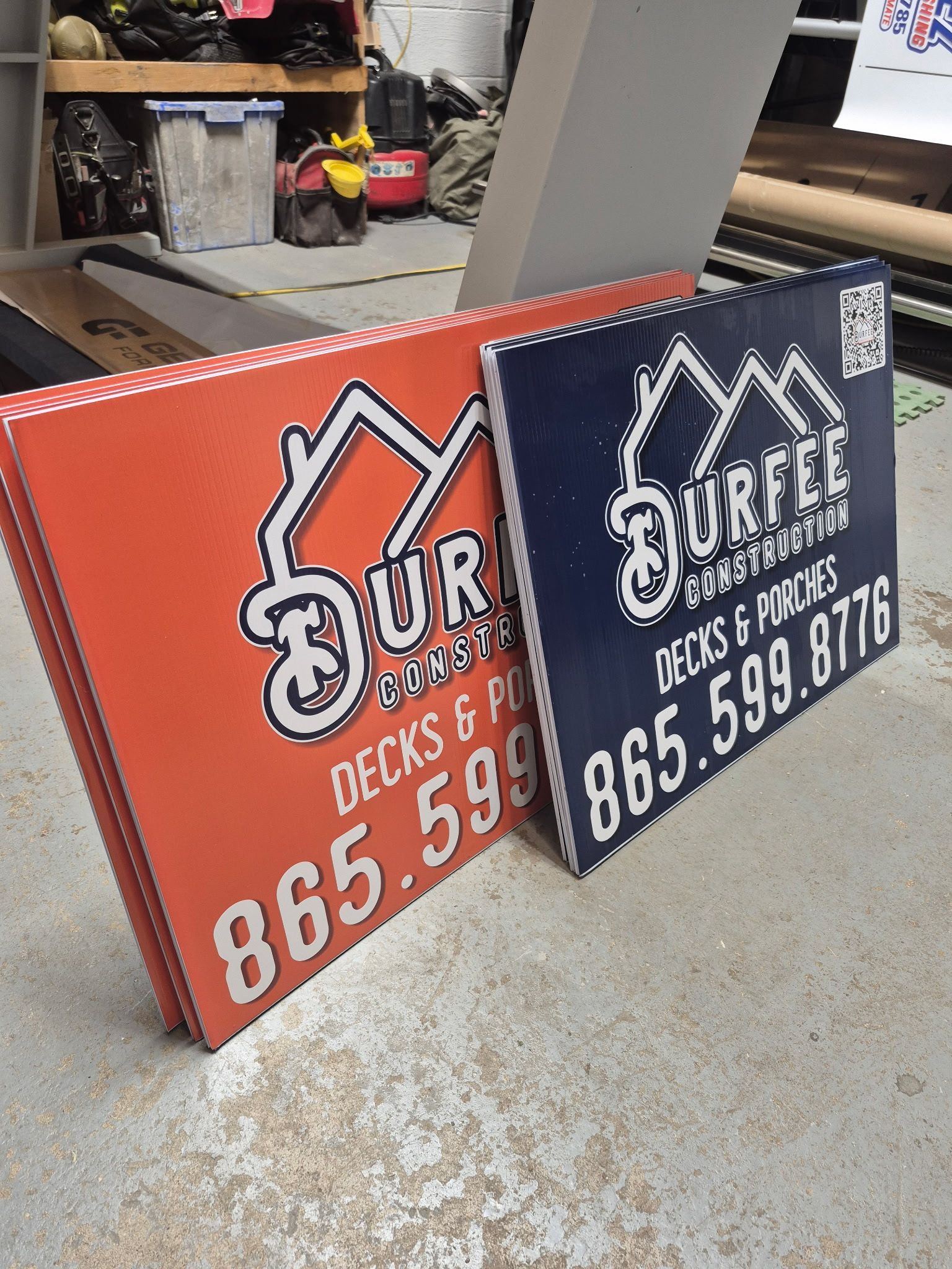 Two signs stacked on top of each other one of which says our decks & patio