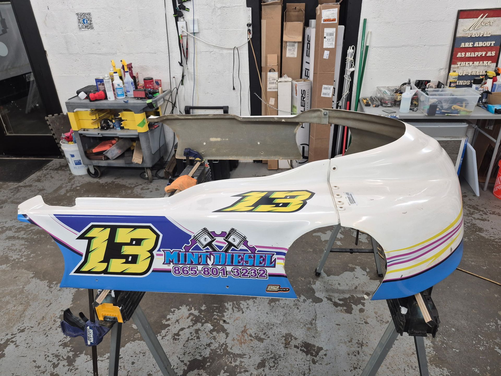 A race car bumper with the number 13 on it