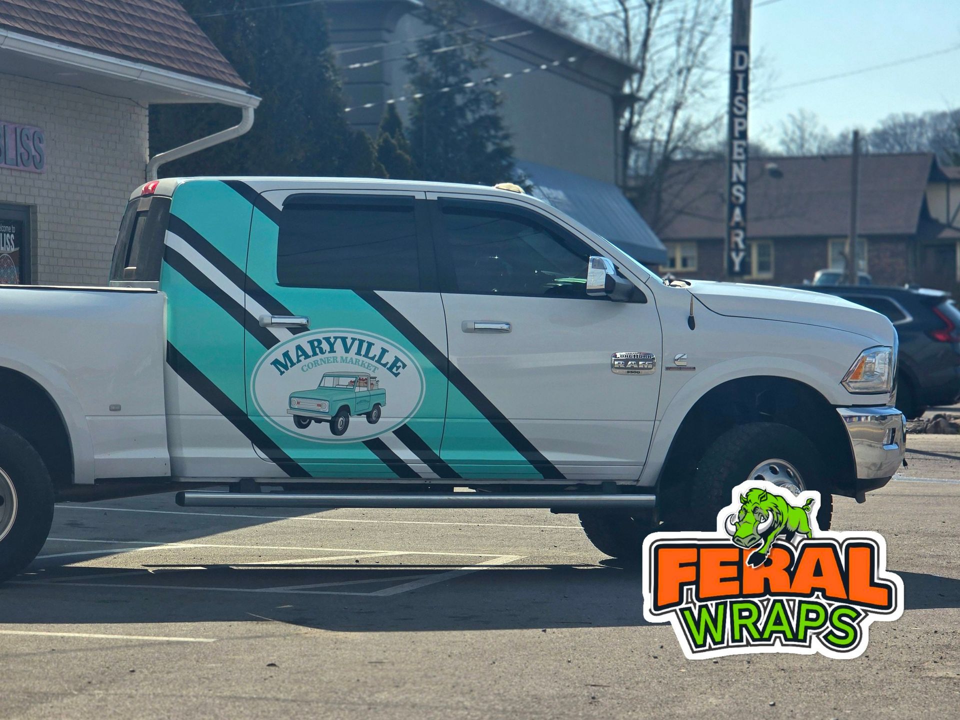 White pickup truck with turquoise and black graphic promoting Maryville. 