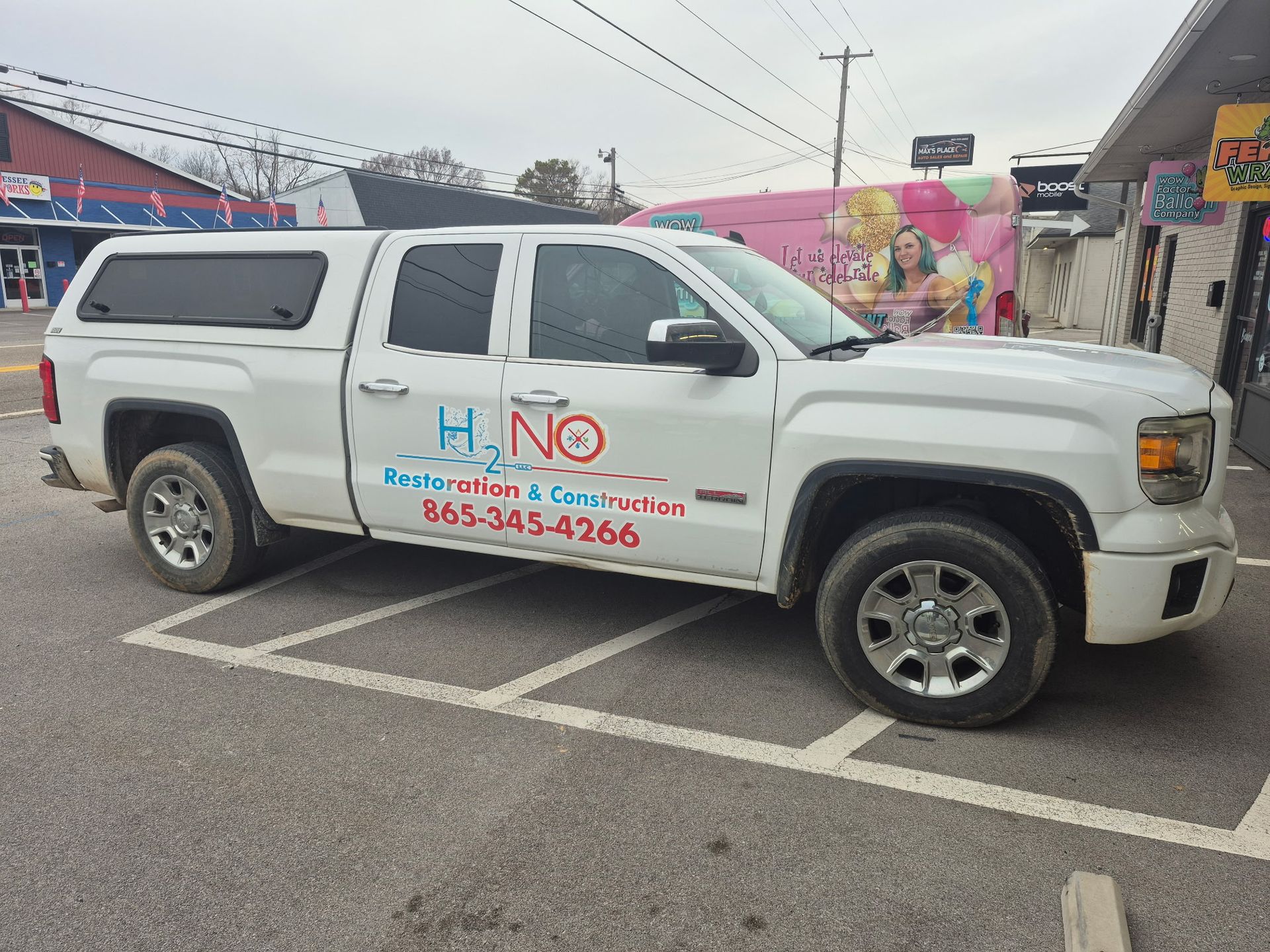 White truck with business logo 