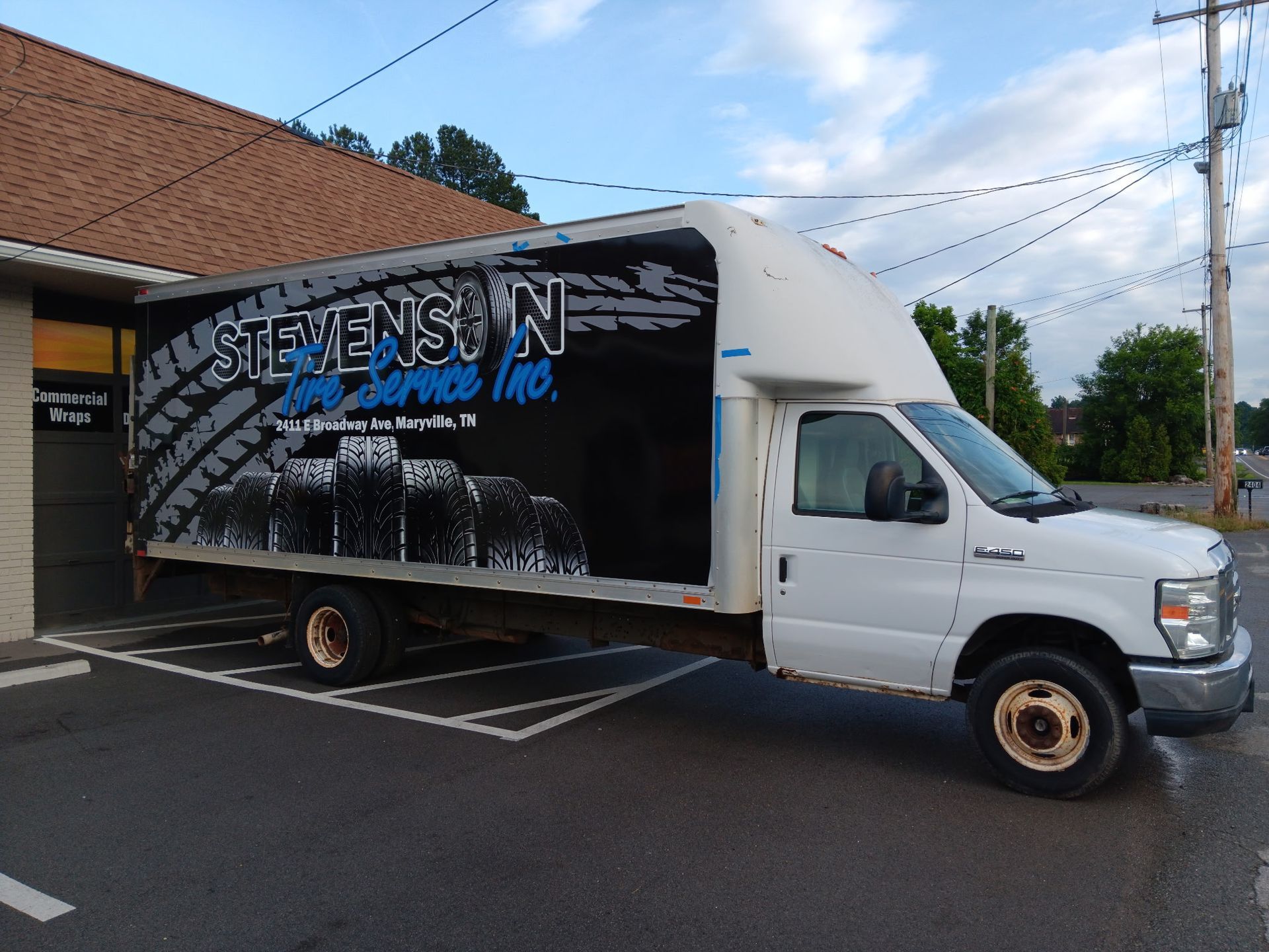 A stevenson truck is parked in front of a building