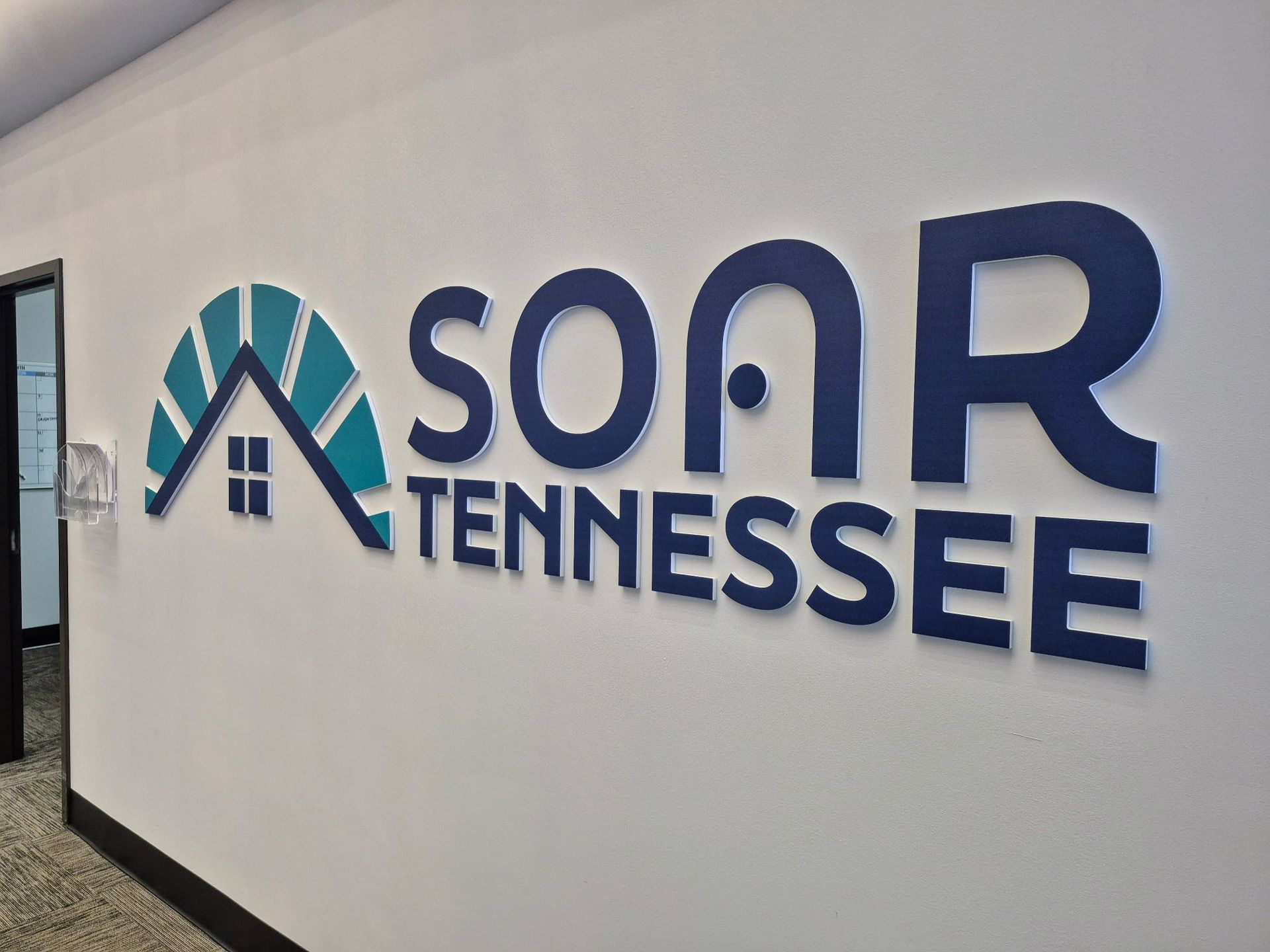 A sign on a wall that says soar tennessee