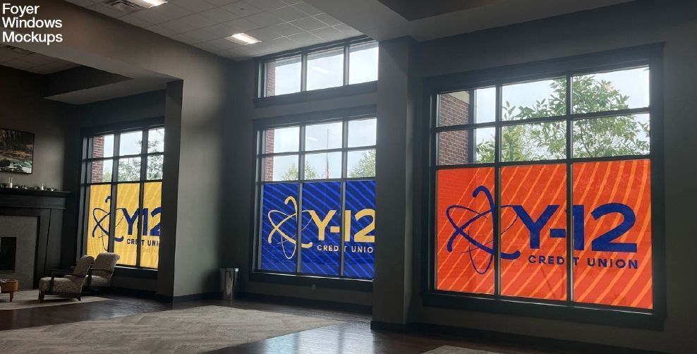 A living room with a lot of windows and a fireplace.