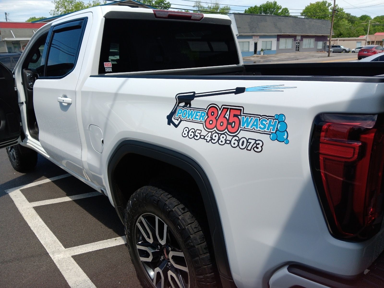 A white truck is parked in a parking lot.