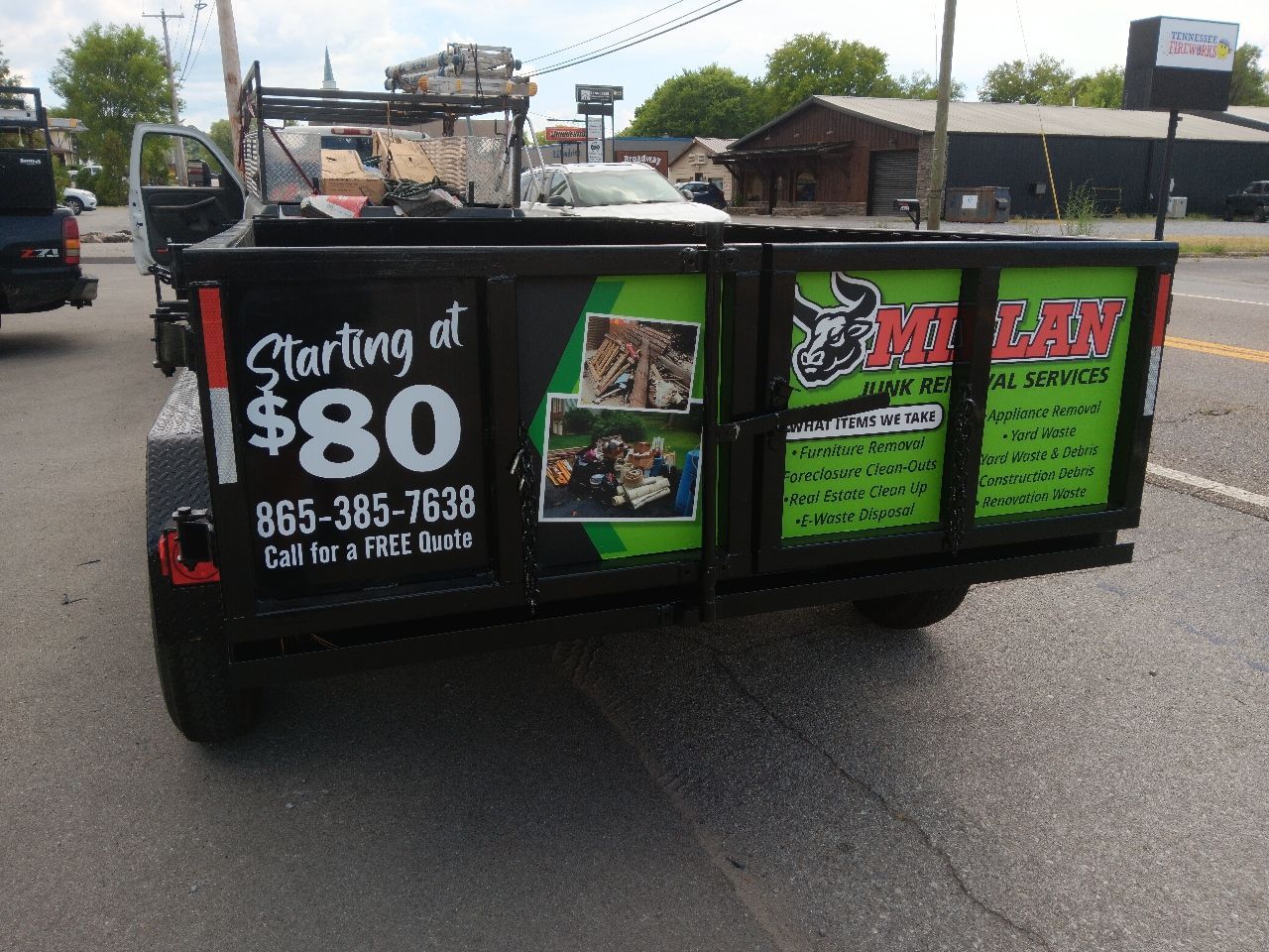 A dumpster trailer with a sign that says starting at $ 80