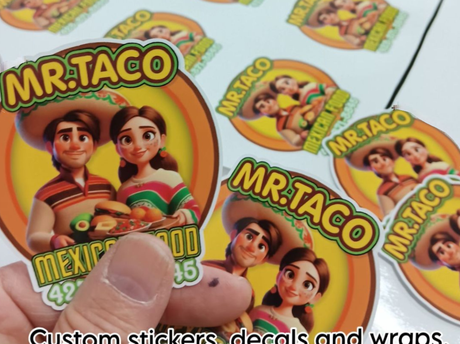 A person is holding a stack of mr taco stickers