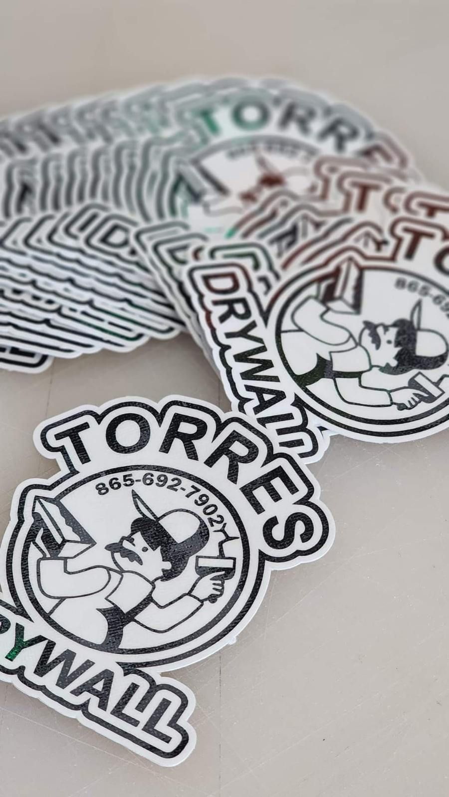 A bunch of stickers that say torres drywall on them