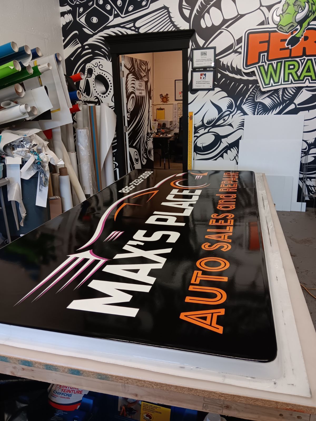 A sign for max 's place auto sales is sitting on a table.