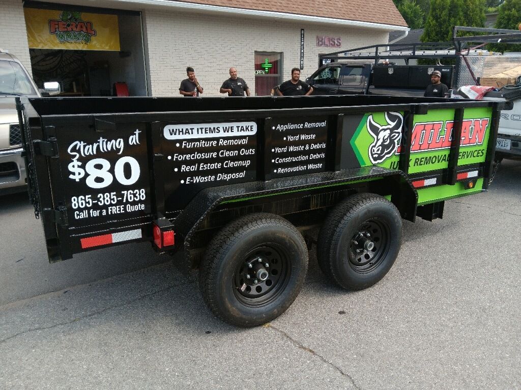 A dumpster trailer is parked on the side of the road.