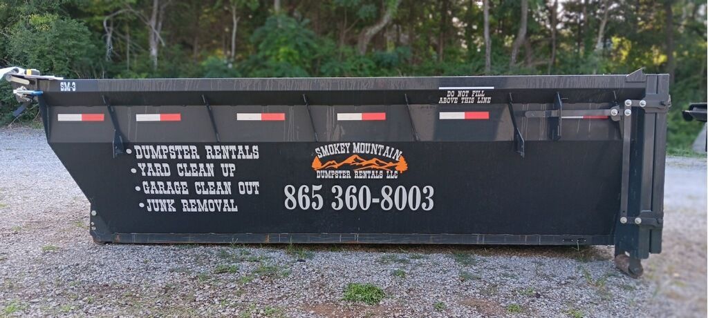 A dumpster with a phone number on it