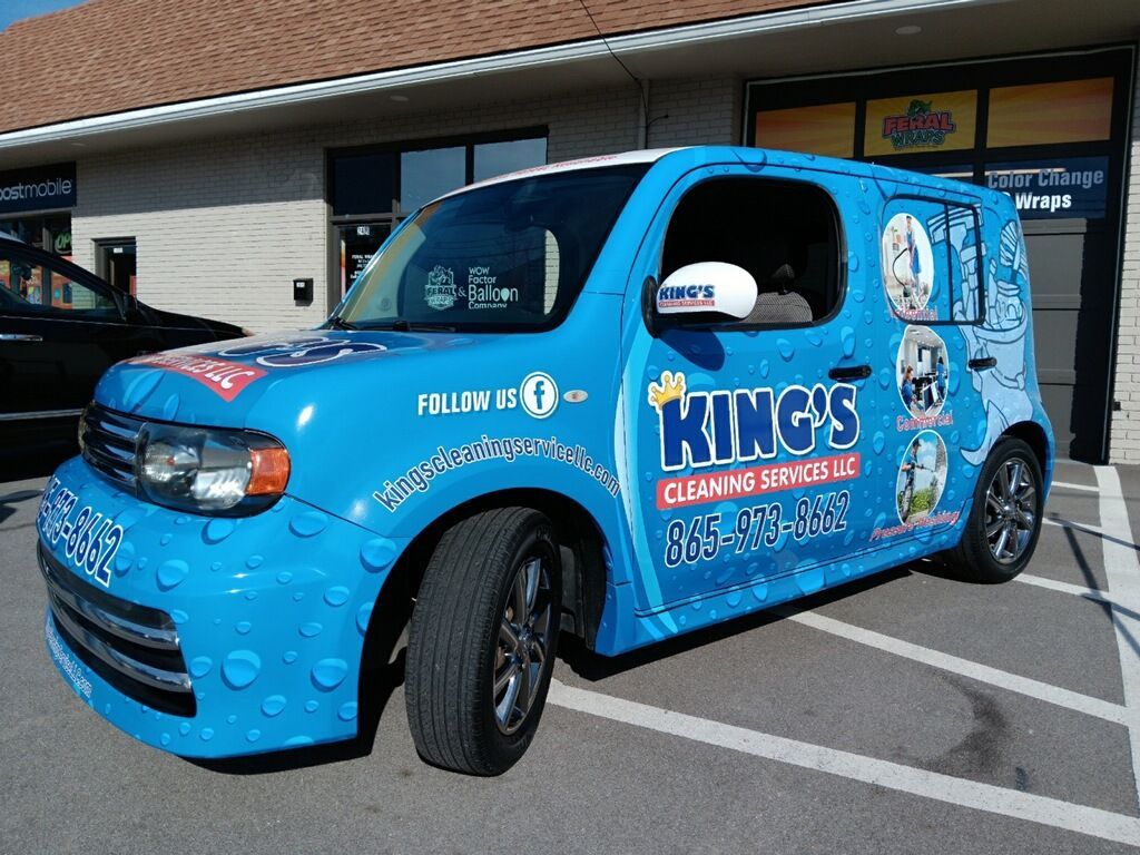 A blue king 's cleaning van is parked in a parking lot