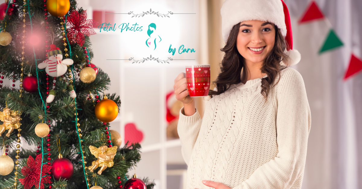 a pregnant woman in a santa hat holds a cup in front of a christmas tree